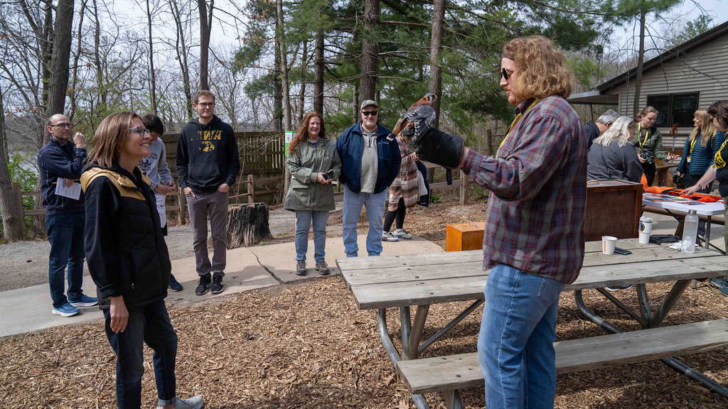 An informational session outdoors with Iowa Raptor Project staff